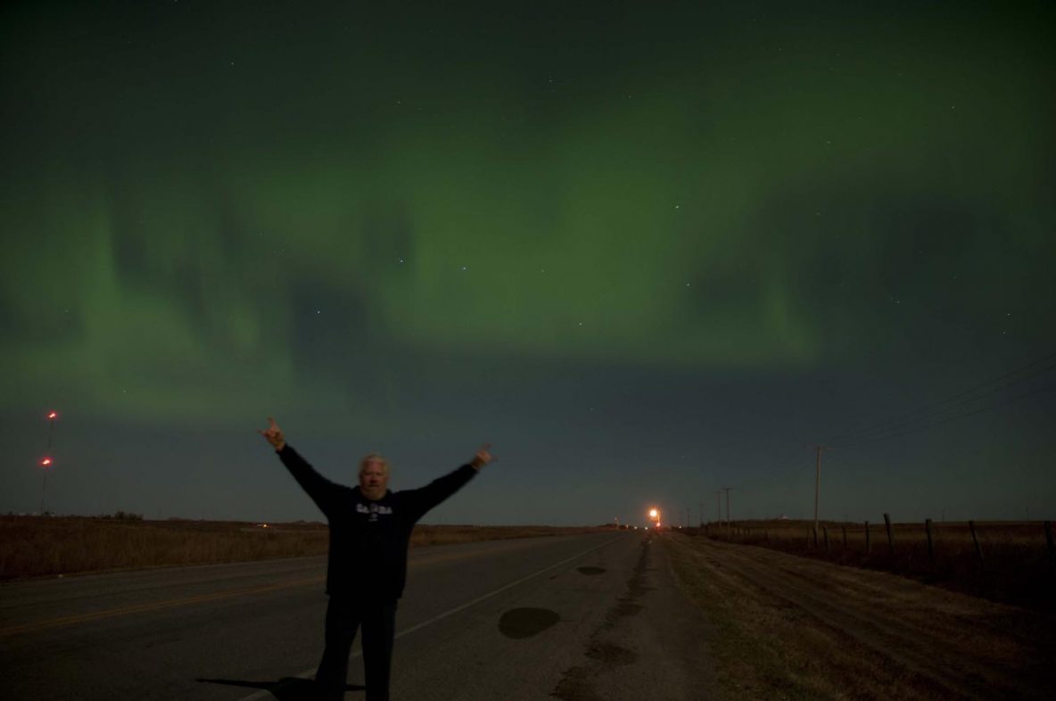 Nico and aurora borealis, northern lights near Pilot Butte, Saskatchewan