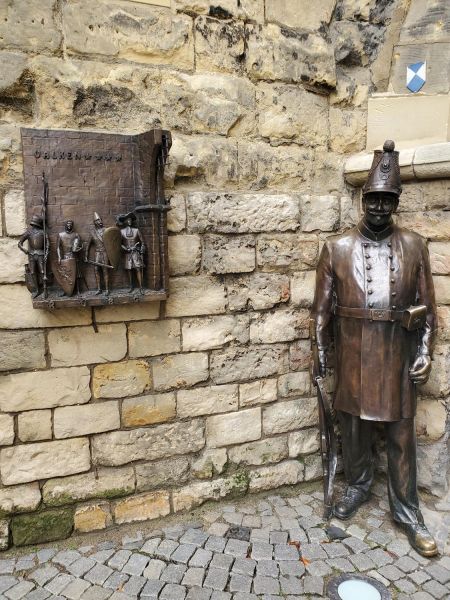 Gatekeeper statue and knights plaque near Grendelpoort